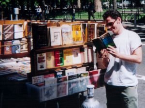 New York bookseller movie, 'BookWars': Reading Nietzsche at a sidewalk bookstand in Manhattan, from the New York bookseller documentary 'BookWars'